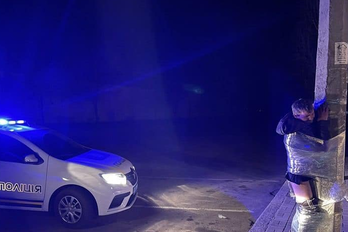 KyivPost's tweet photo. In Mykolaiv, #Ukraine, people punished a prowler by taking off trousers from him and binding him to the post with a clingfilm. https://t.co/6JOYnUoiWt