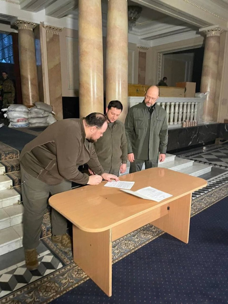 maksymeristavi's tweet photo. in military wear and with indoor barricades behind him,  president @ZelenskyyUa signs a fast-track eu membership request for ukraine. regardless of the reply, this will go down as one of the boldest moves in european history https://t.co/9vOUPgiDpa