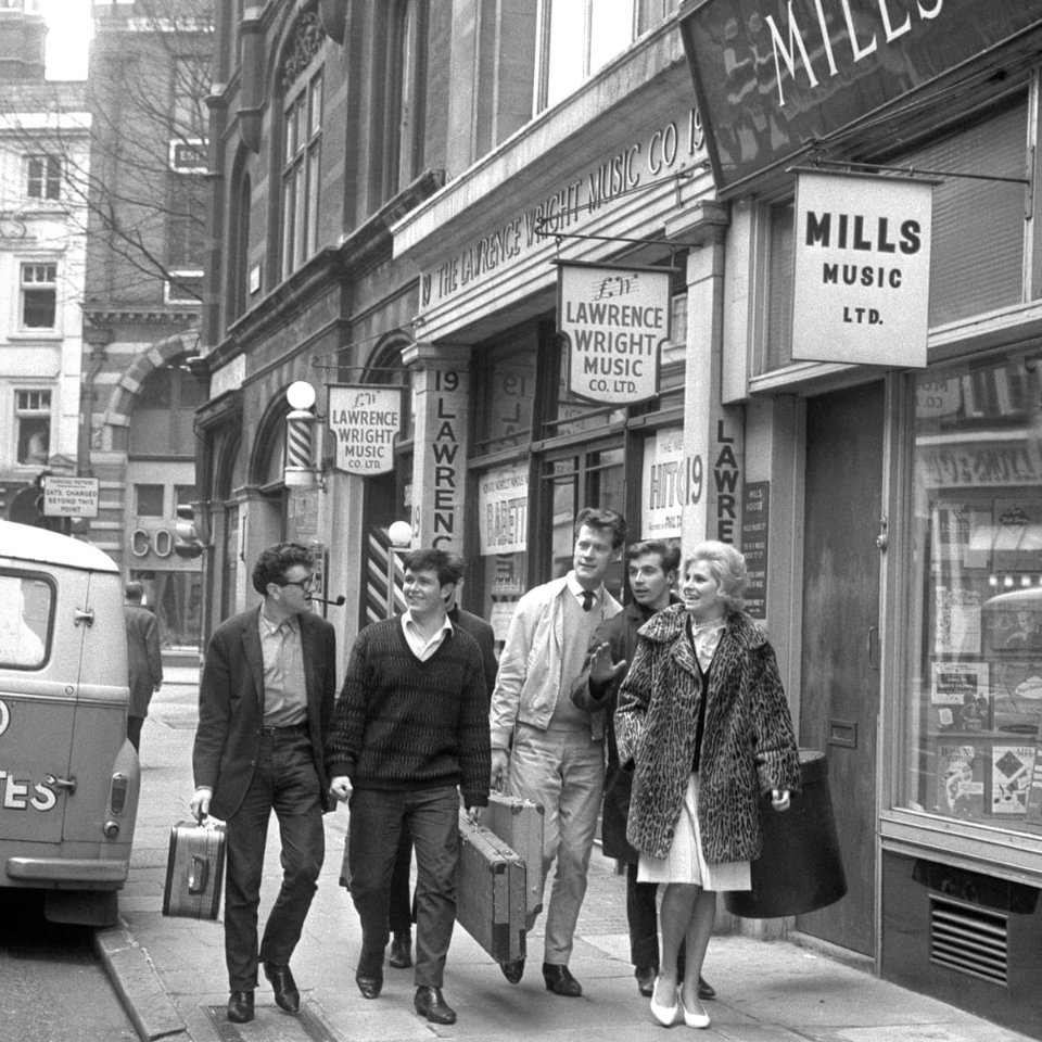Knowledgepoint's tweet image. Tin Pan Alley pictured in 1961.
Melody Maker started out at number 19 in 1926. Next door at number 20 Sir Elton John, then simply plain old Reg Dwight, worked as the office boy for Mills Music and was paid £5 per week in 1965.