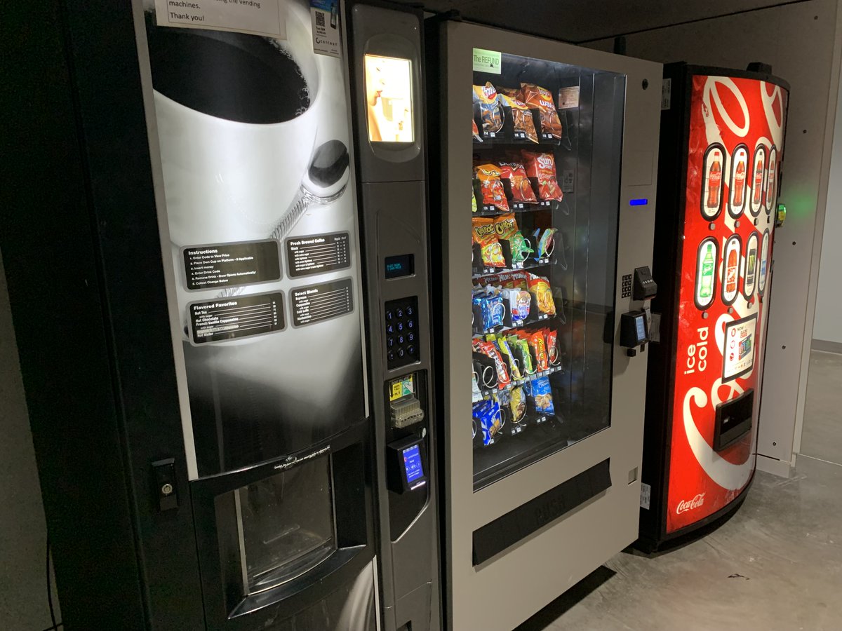 A row of beverage and food vending machines