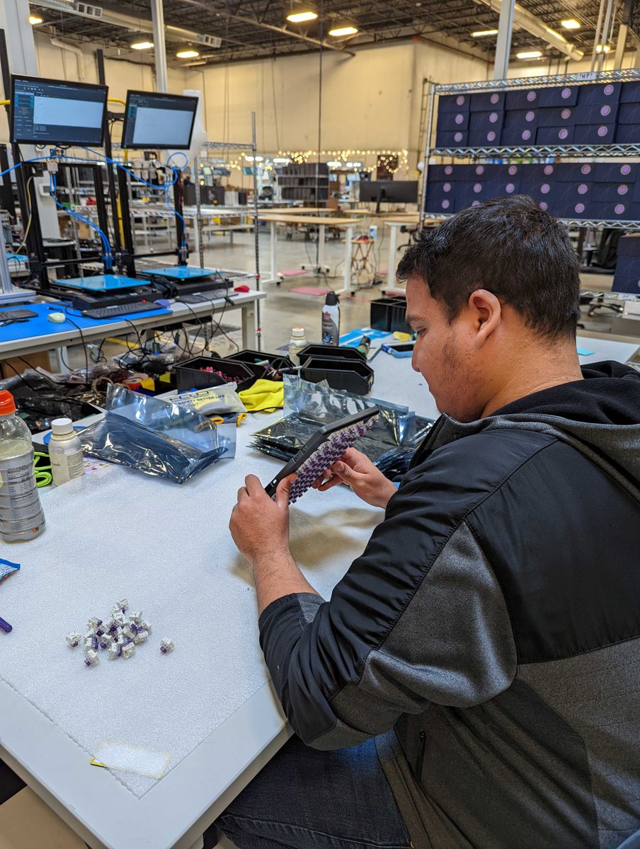 system76's tweet photo. After all the switches have been placed in the upper housing, Ruben checks to make sure the pins are straight so that the keyboard is ready for testing.

#howitsmade #monday #howitsmademonday #madeindenver #madeinusa #launch #qmk #customkeyboard https://t.co/HXfU2Nr8zJ