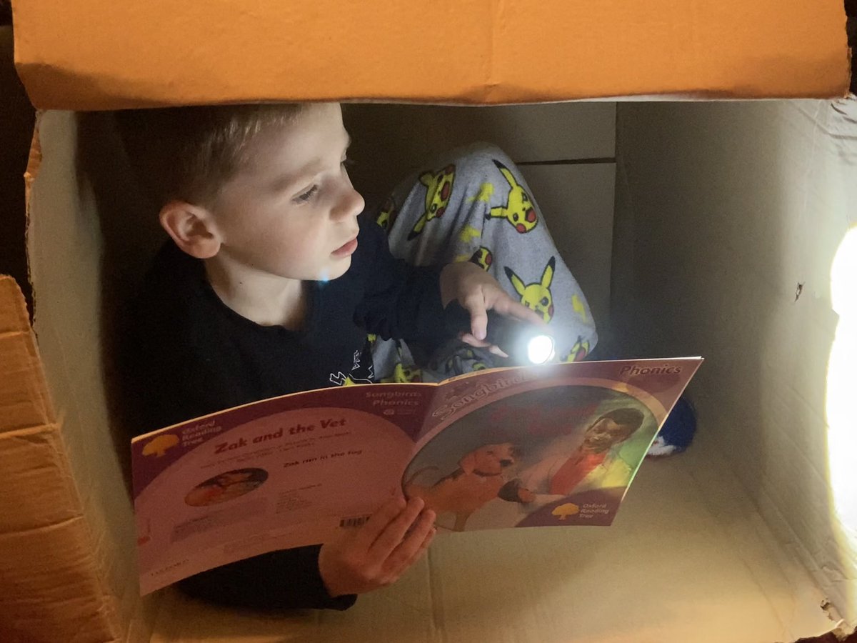 Reading ‘Zak and the vet’ in a cardboard box. <a href="/sacred_heartps/">Sacred Heart Primary</a> #sacredheartinneverland