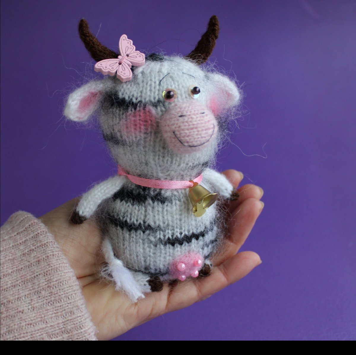 'A cute little hand knitted cow that will happily sit on your shelf, desk or windowsill.\nYou can present this exclusive gift to your girlfriend, colleague or even grandma on any occasion.\nThis miniature toy won’t leave anyone… etsy.me/3hx0Q5r #toycow #cowplush