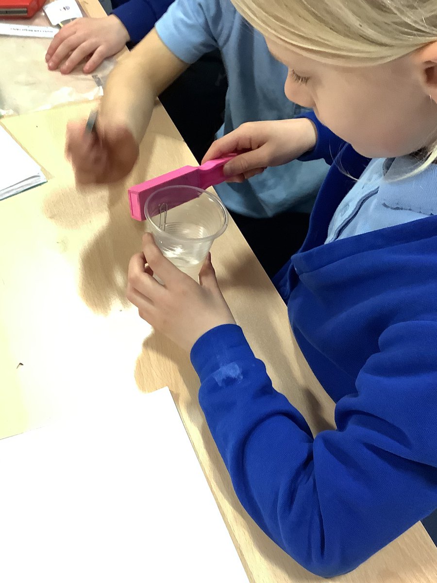 YarmPS's tweet photo. The children in KS1 this afternoon were faced with a problem in their Science lesson. How can I get the paperclip out of the water without touching/spilling the water or getting my hand wet? The children used their new knowledge of magnets to come up with a solution🧲 #ypsscience https://t.co/P1W7IQq3Vq
