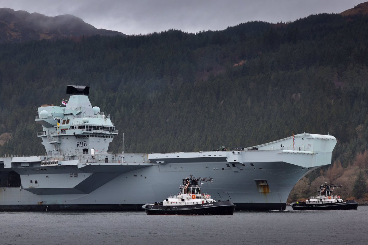 RNinScotland's tweet photo. The Nation’s Flagship @HMSQNLZ is once again at #GlenMallan jetty on Loch Long. It’s the @RoyalNavy carrier’s first visit since last March when she visited ahead of her successful Carrier Strike Group deployment #CSG https://t.co/wGJFoiYWwY