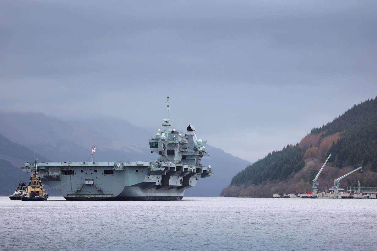 RNinScotland's tweet photo. The Nation’s Flagship @HMSQNLZ is once again at #GlenMallan jetty on Loch Long. It’s the @RoyalNavy carrier’s first visit since last March when she visited ahead of her successful Carrier Strike Group deployment #CSG https://t.co/wGJFoiYWwY