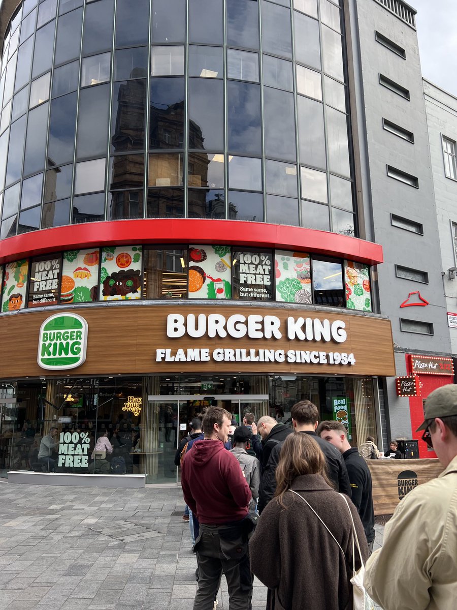 Queues deep in to Leicester Square for Burger King’s ‘NEW 100% MEAT FREE!’ restaurant below our studio. Congratulations! Come try the Katsu Vegan Royale …and head upstairs for a side order of architecture #BurgerKing #Leicestersquare