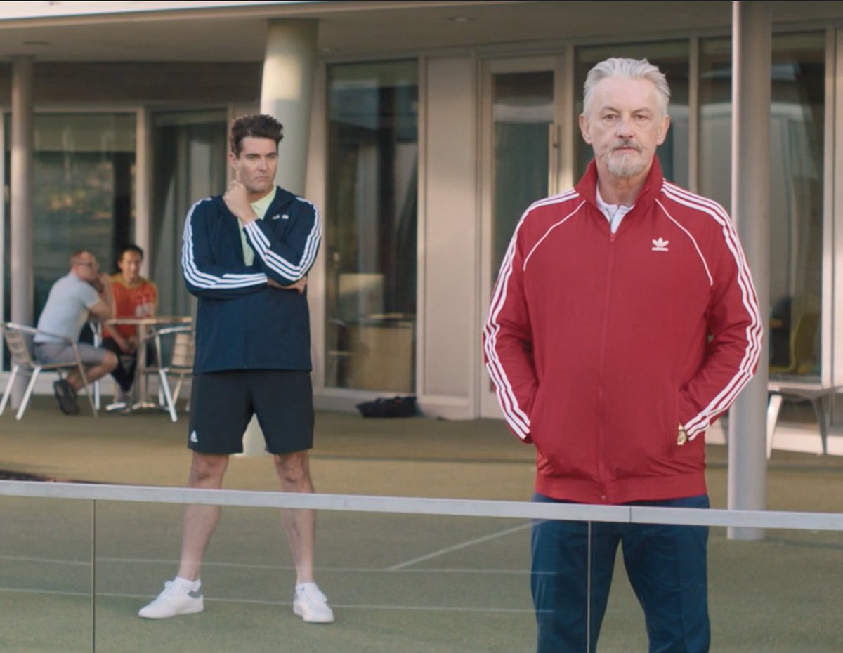 Tommy Flanagan, who stands here as lead tennis coach Petrov, has had a lot of experience on the big screen, including acting in Sons of Anarchy, Braveheart, and Guardians of the Galaxy... still, there has never been a character that Flanagan doesn't play well.