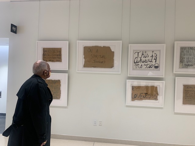 dcpl's tweet photo. Today @WashArchbishop stopped by the MLK Library to view a new exhibition by IVC #InvisibleWords. The exhibition is "an exercise in empathy," featuring a curated collection of signs created by people experiencing homelessness worldwide. Learn more at https://t.co/15WNy5FUL9. https://t.co/E6UEHpSLwq
