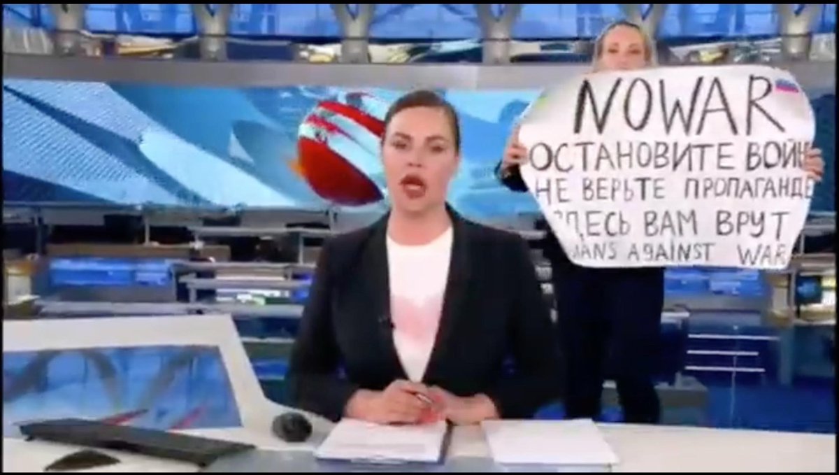 CalltoActivism's tweet photo. BREAKING: Russia’s main propaganda Channel One was interrupted by a young woman holding a sign opposing Putin’s invasion of Ukraine. 

RT to THANK this brave woman for putting her life on the line to speak out against this immoral war! https://t.co/fp3f7A5qwz