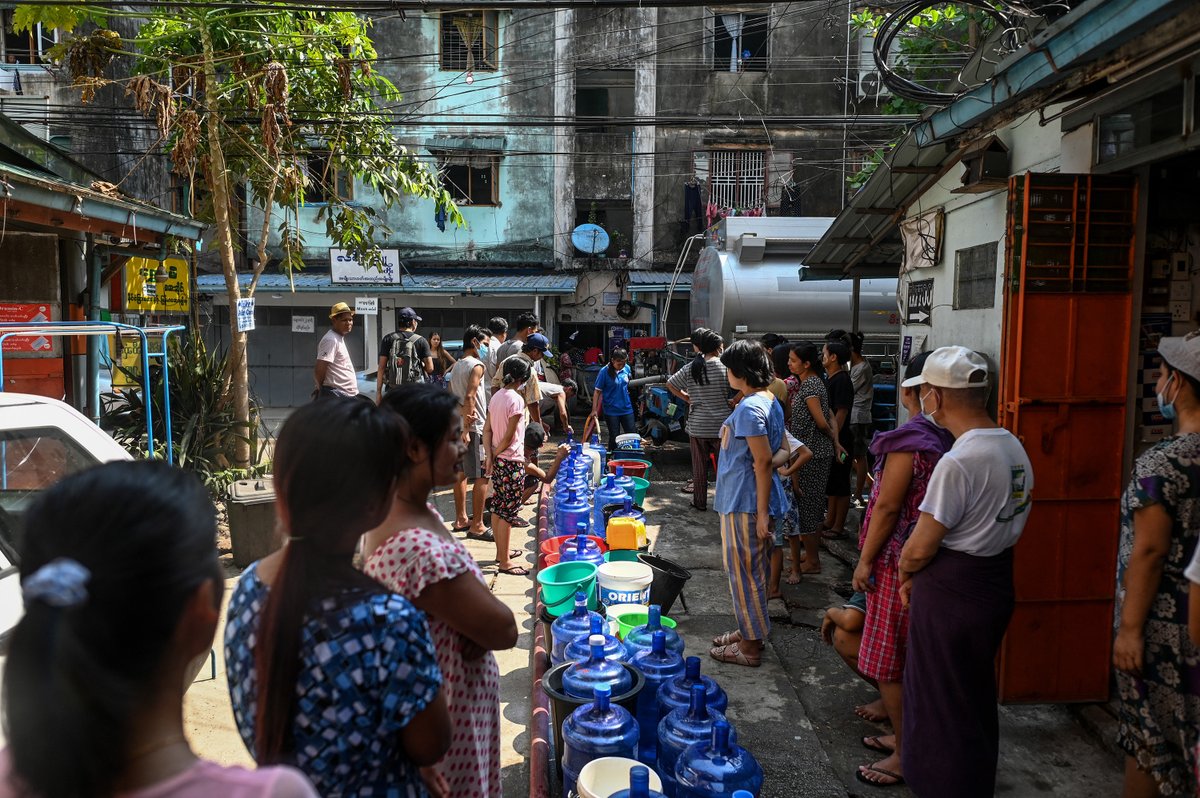 RadioFreeAsia's tweet photo. Rolling power outages have left many residents in Myanmar’s largest city of Yangon lining up for water — carrying large blue containers and plastic buckets as the country continues to plunge into economic disaster more than a year after the military seized power. 

Photos: @AFP https://t.co/Q1IBptvpgT