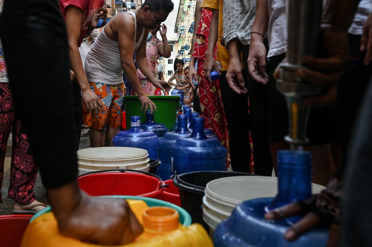 RadioFreeAsia's tweet photo. Rolling power outages have left many residents in Myanmar’s largest city of Yangon lining up for water — carrying large blue containers and plastic buckets as the country continues to plunge into economic disaster more than a year after the military seized power. 

Photos: @AFP https://t.co/Q1IBptvpgT