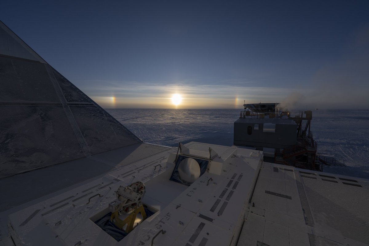 Late sun dogs at the South Pole low in the sky, possibly the last of the season before the equinox sunset next week and the commencement of the long polar night at 90°South. This view from @SPTelescope, with @BICEP_Keck at right @NSF #SouthPole #Antarctica pic @aman_chokshi