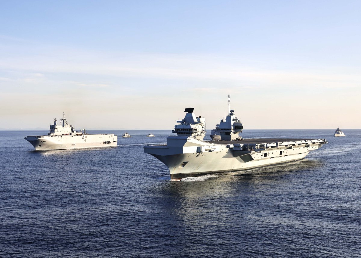 HMS Prince of Wales sails in the formation with another ship in the background