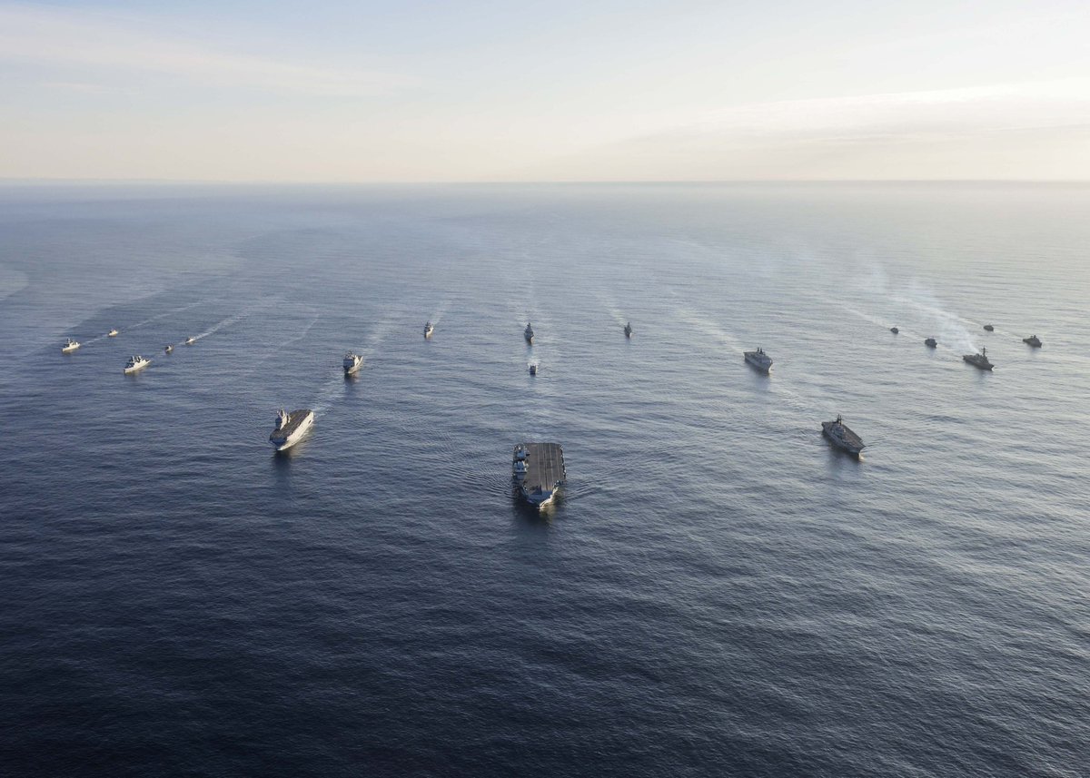 The ships sail alongside each other in w die image taken from above