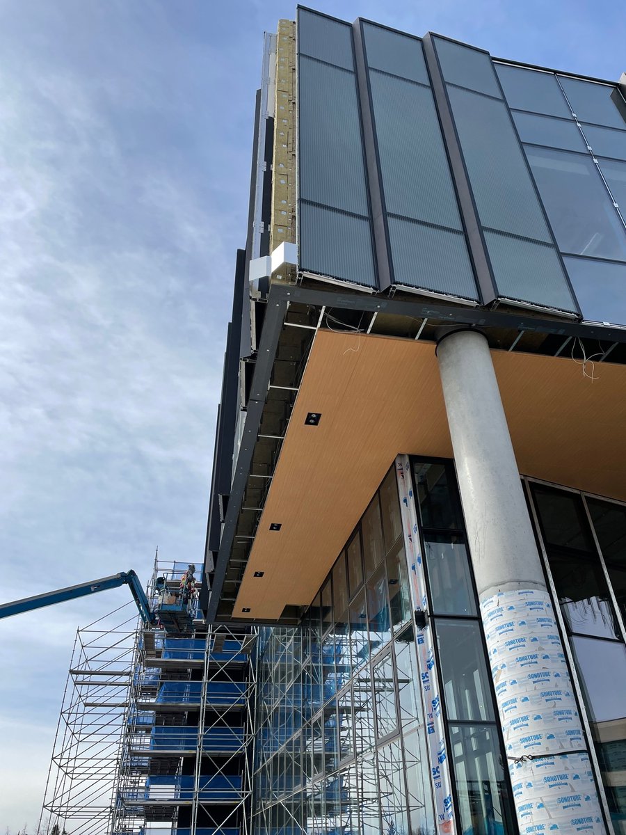 EDMathisonHall's tweet photo. South view of Mathison hall, double curtain wall, level two, three and four. Wood panelling and lighting is being installed in the soffit. https://t.co/MdXtvXpSax