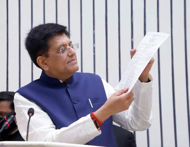 Picture of Union Minister highlight some points from a document in his hand during his address