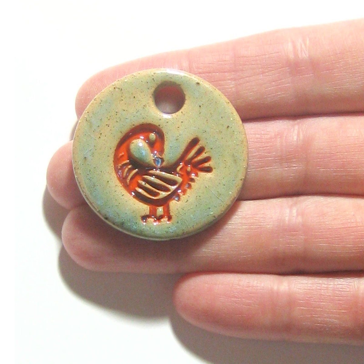 JKCJewelry's tweet photo. Orange Sankofa Large Artisan Pendant Necklace, Adinkra Necklace, African Symbol, Ceramic Pendant, Stoneware, Akan Tribe Symbol https://t.co/ebohPhPGN5 #ceramics #handmade #art #pottery #CeramicBead https://t.co/vGRSwBB3vh