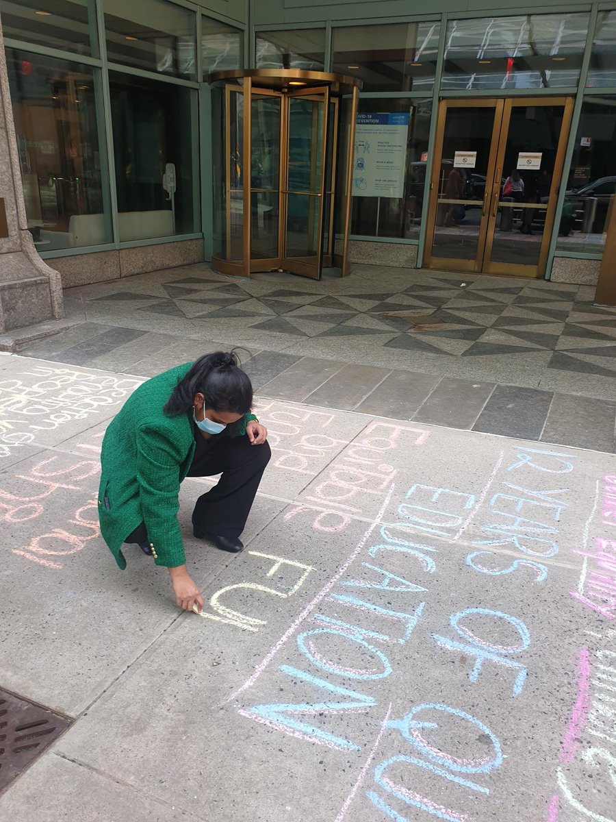 The photo shows the UN Secretary-General's Envoy on Youth Jayathma Wikramanayake chalking messages on the ground.