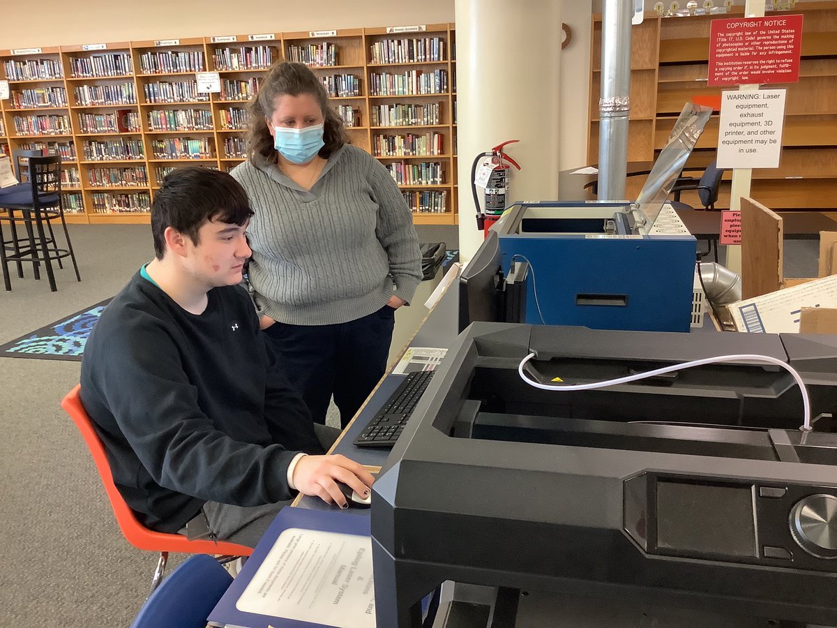 LatrobeHighPost's tweet photo. Mrs. Mamaril assists junior Luke Houle who is creating a project using a laser cutter for the marketing class. https://t.co/gFzCDuBEsU