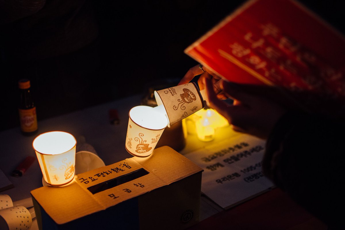 A supporter lights a candle for a candlelight vigil for peace in Ukraine in front of the Russian Embassy in Seoul, South Korea.