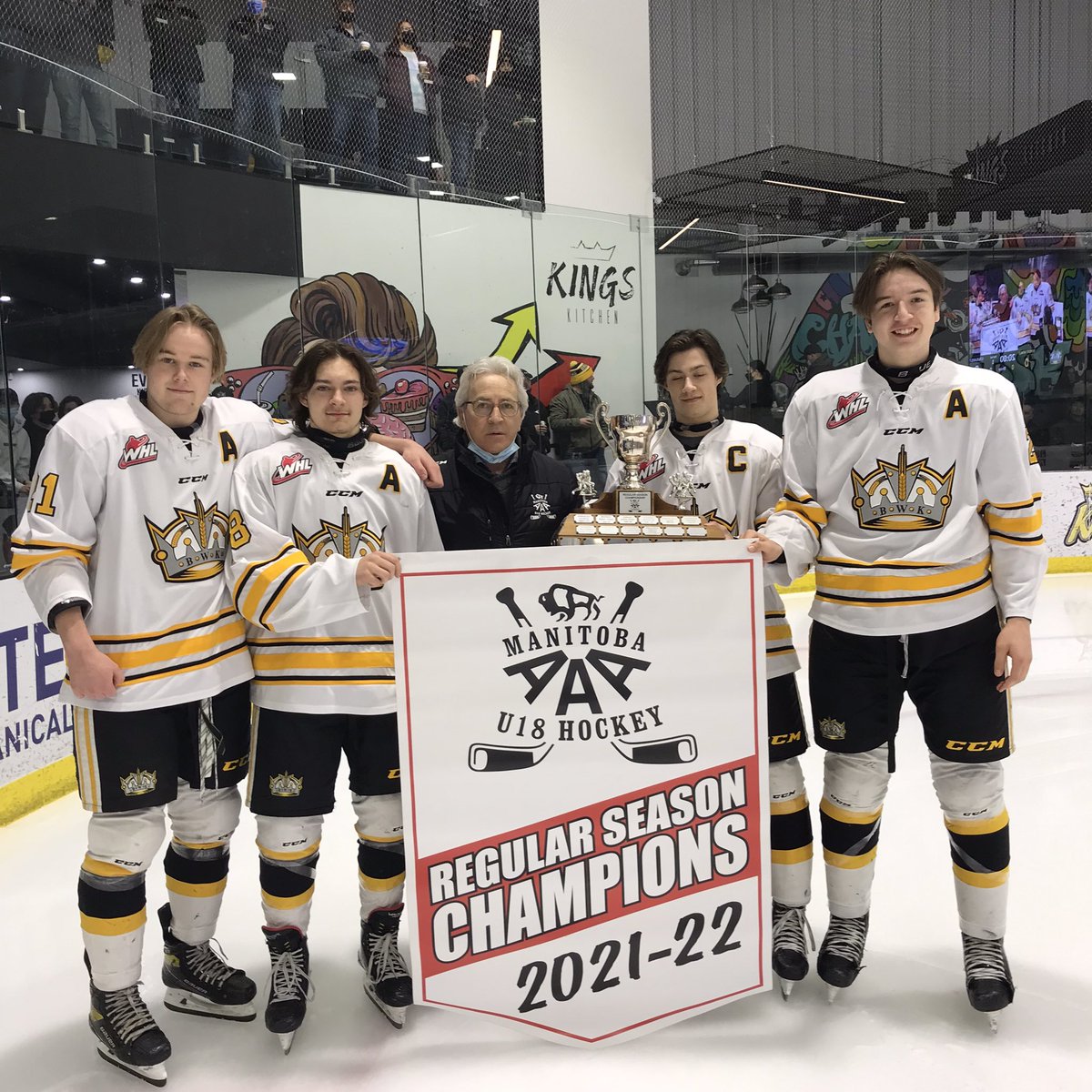 Glen Parker Vice-President of the Manitoba AAA U18 Hockey League presenting the regular season trophy and banner to Ethan Guthrie Nolan Chastko, Braden Keeble and Callum Halls. Brandon finished with a 33-4-3 record for 69 points