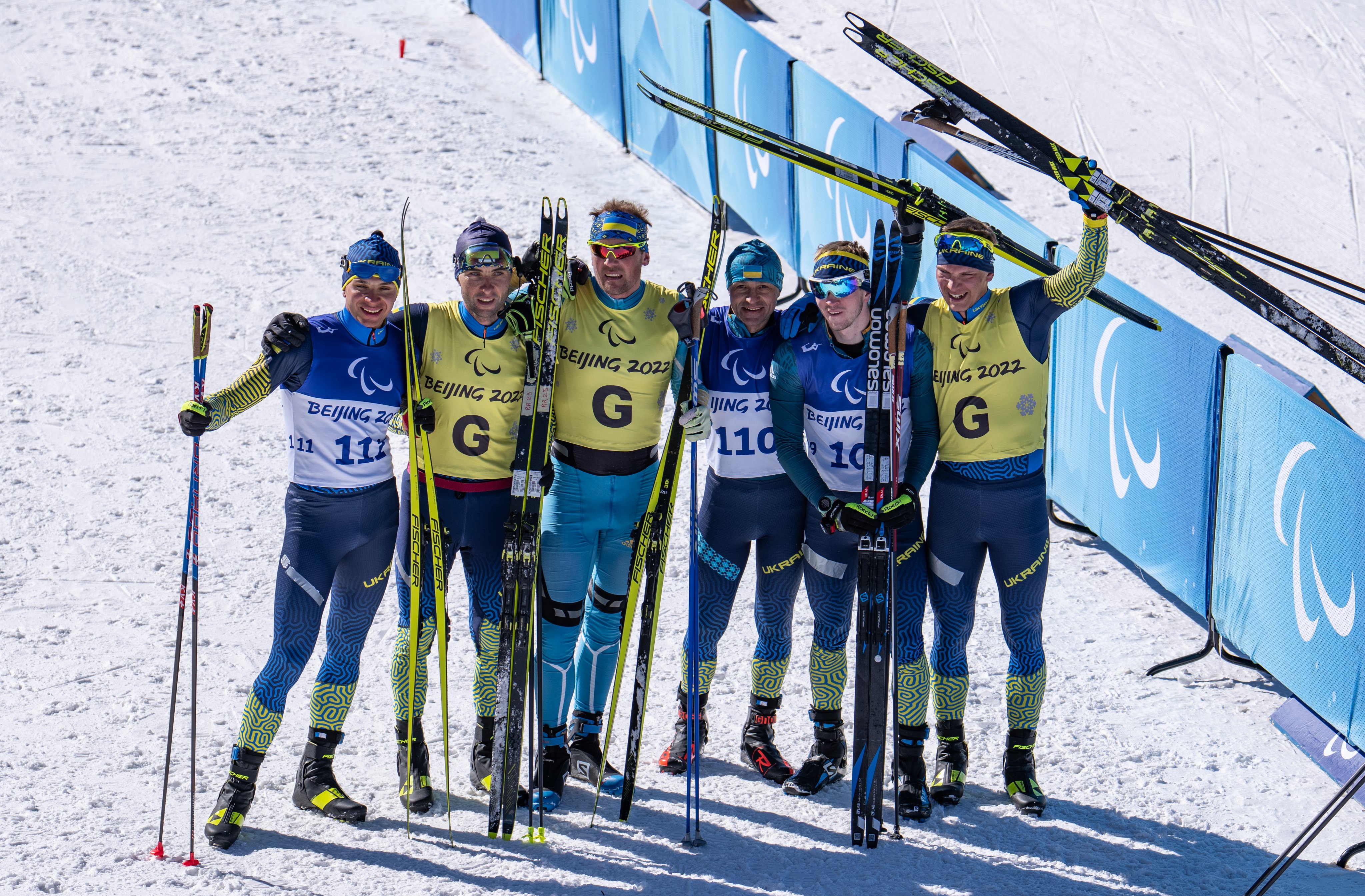 Ukraine's Men Vision Impaired Sprint Biathlon teams posing after a board sweep in the event 