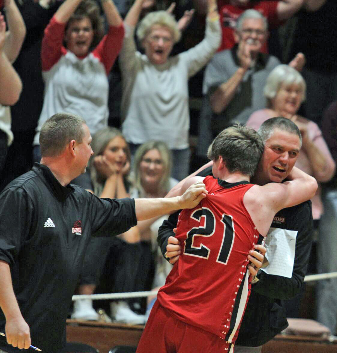 Borden coach Doc Nash and his son Kasym share a special moment after the Braves' victory over CAI in Saturday night's sectional final at Borden.