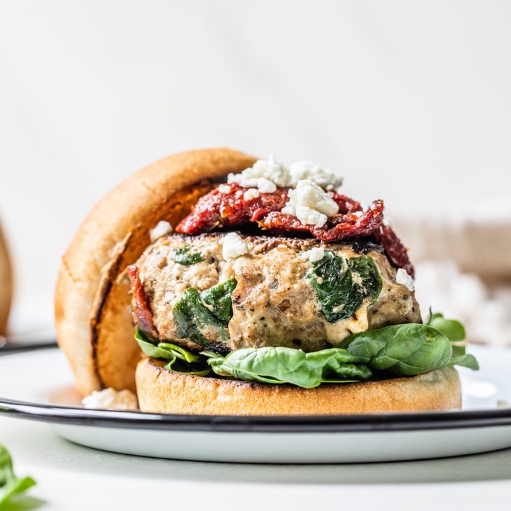 Patiently waiting for grilling season like...🥲 If it's too cold to bring the grill out where you live, make these flavor-packed stuffed Greek turkey burgers on your stove!🍔