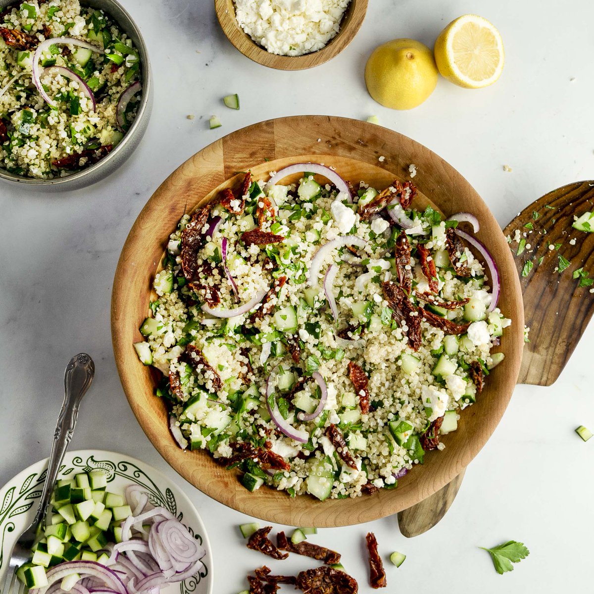 This flavor-packed quinoa salad is full of healthy ingredients! Loaded with quinoa, spinach, crunchy cucumber and red onion, fresh feta and topped with a tangy lemon dressing, this is sure to become your go-to salad!