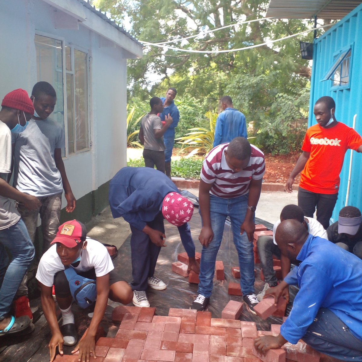 YoungAfricaInt's tweet photo. Young Africa is all about learning-by-doing. And we walk the talk: @YoungAfricaZimbabwe students enjoy a hands-on lesson on paving at the Young Africa International Hub. Bricks donated by @BetaHoldings
#youth #skills #training #competencebasedlearning #CSR https://t.co/1rg8Zum1Km