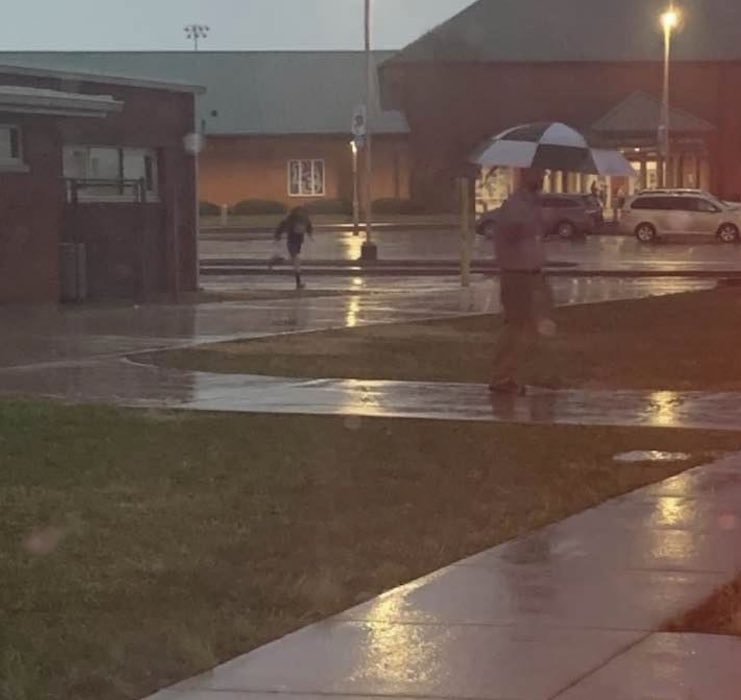 LCMSHawks's tweet photo. Sideways rain?  No problem!  Mr Reed has our car riders covered this morning! https://t.co/JmqVONzfPr