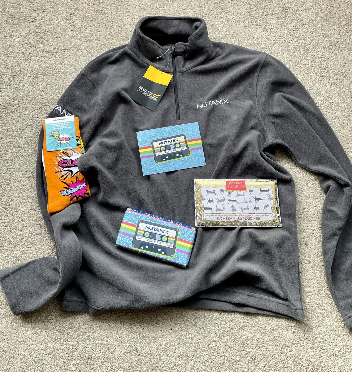NimbleTechie's tweet photo. Big thanks to @nutanix for the gift package that arrived today. A great fleece which is always handy in this weather, along with some quality chocolates. Oh the funky socks too! #NutanixTechieUKI https://t.co/811qT41cMP