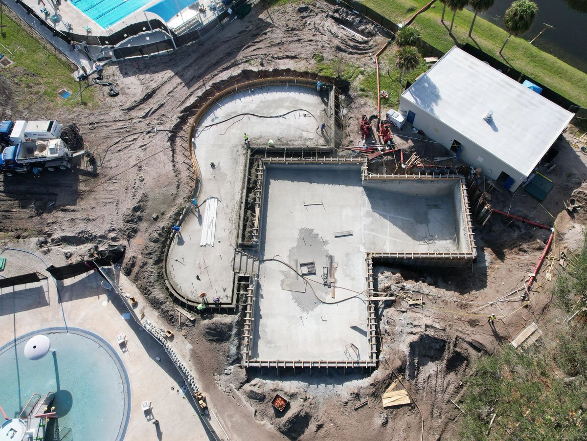 CityofPBG's tweet photo. The Main Pool renovations are going 'swimmingly'! 🏊 Check out this aerial shot of the pool's new layout! Who's excited for the new pool, featuring a beach entry 🏖️ , sun shelf ☀️, a 16 foot slide 🌊 & so much more, to open back up? 🙋 #CityOfPBG #AquaticComplex https://t.co/I9ZMFp4v9Y