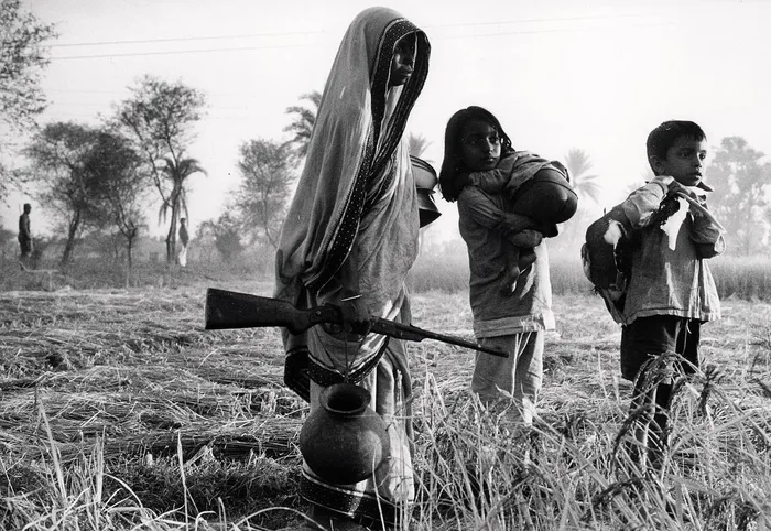 reportersujan's tweet photo. Bangladesh 1971. A mother stands guard over her children. https://t.co/5ZnvppyXlf