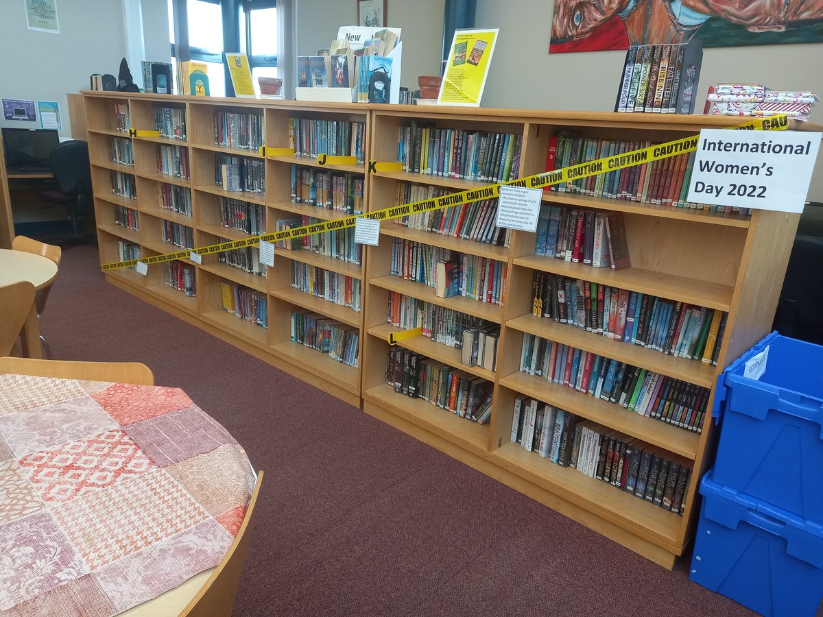 CryptLibrary's tweet photo. The #CryptLibrary is marking #InternationalWomensDay by symbolically restricting access to 79% percent of the books in the main area. Quotations attached to the tape are from UNICEF, The World Bank, WHO, and Plan International. #IWD2022 https://t.co/cBRd7TPe7N