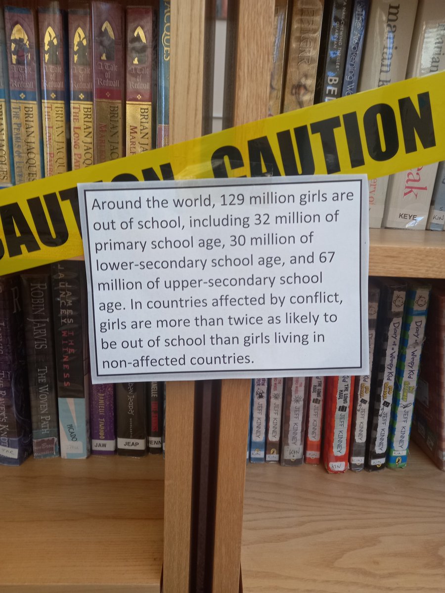CryptLibrary's tweet photo. The #CryptLibrary is marking #InternationalWomensDay by symbolically restricting access to 79% percent of the books in the main area. Quotations attached to the tape are from UNICEF, The World Bank, WHO, and Plan International. #IWD2022 https://t.co/cBRd7TPe7N