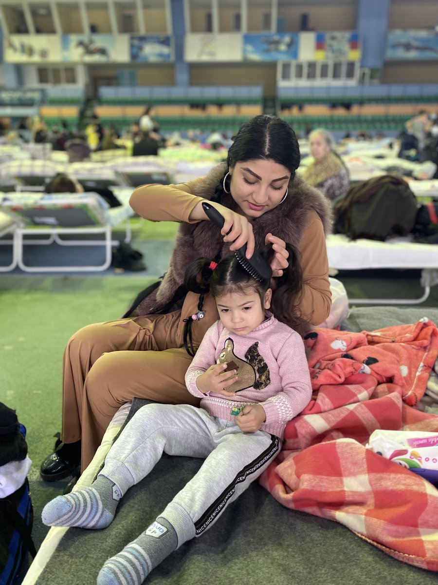 They’ve spent the night on a camp bed in a hall in a foreign country. They’ll probably be here again tonight and don’t know what lies ahead. 

But this mother is trying to keep as much normality as possible for her daughter. That means hair brushed and ready for the day ahead.