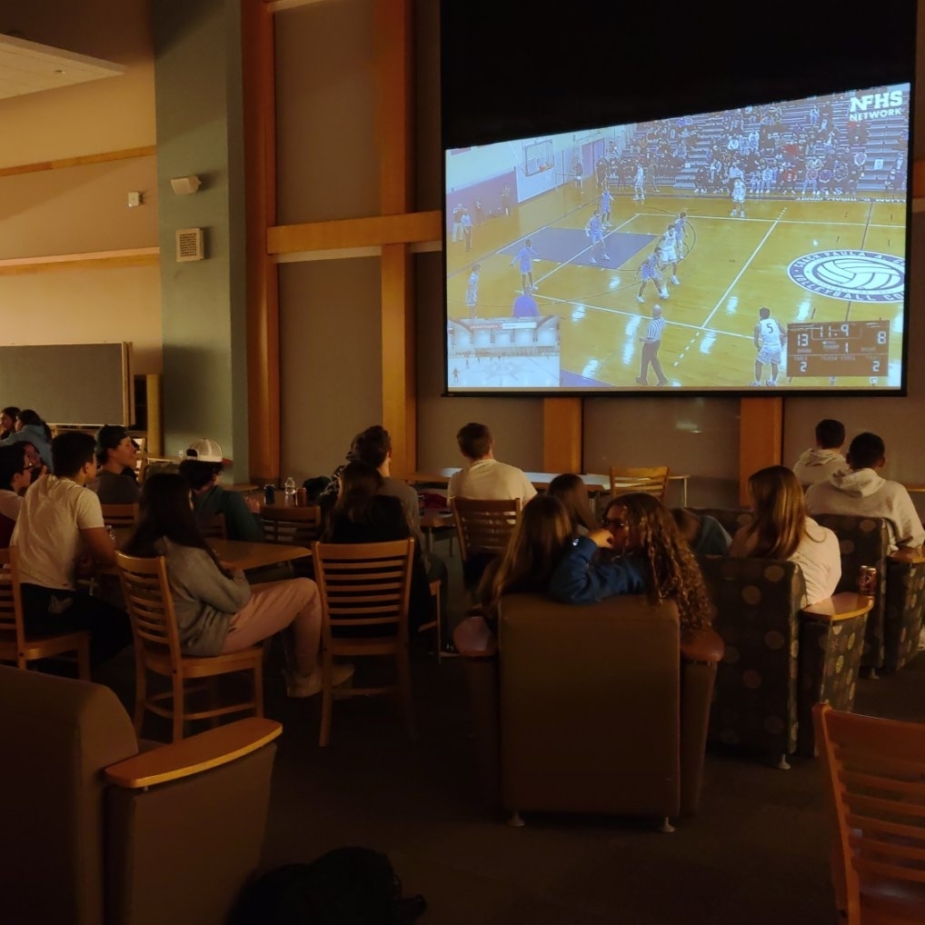 CESDracut's tweet photo. DHS watch party is growing. Now split-screening Dracut/Tyngsborough Hockey (in Buzzards Bay against Hanover) along with Boys Basketball, who travelled to Holyoke. Next up, Girls Basketball upstairs as they host Chicopee. Tournament games everywhere. #MIDDIEPRIDE https://t.co/ZTzGbvjOIn