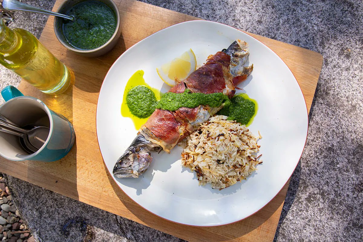 andrewzimmern's tweet photo. Recipe: Prosciutto-Wrapped Grilled Trout with Herb Sauce and Lemon Rice Pilaf: https://t.co/IAQTXDljjO #cookingoverfire #outdoorkitchen @OUTDChannel #troutrecipe https://t.co/grQMYhzjHR