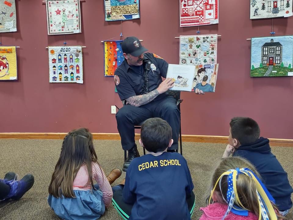 HanoverFire's tweet photo. FF Eric Johnson took some time out of his day yesterday to be a guest story reader at the International Women's Day story and craft time event in the John Curtis Library.  Hanover FF’s love investing in our youth, and take every possibility to teach them fire safety &amp; education. https://t.co/mUMjv5LT16