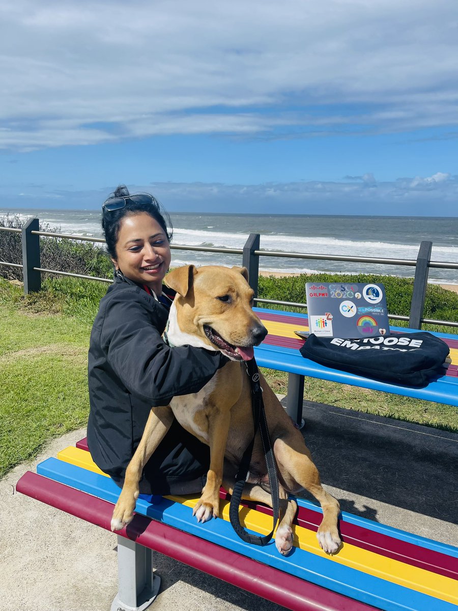 VarshaKanwar's tweet photo. Making the most of a bright sunny day taking afternoon 1:1 check-in and mentoring calls from the beach with my WFH ๐ฉ๐ปโ๐ป buddy, Scooby. #HybridWork at its best. #ThankfulThursday vibes with sun shining after weeks of torrential rains. #WeAreCisco #LifeOnWebex #LoveWhereYouWork https://t.co/jBsCHaQnfZ