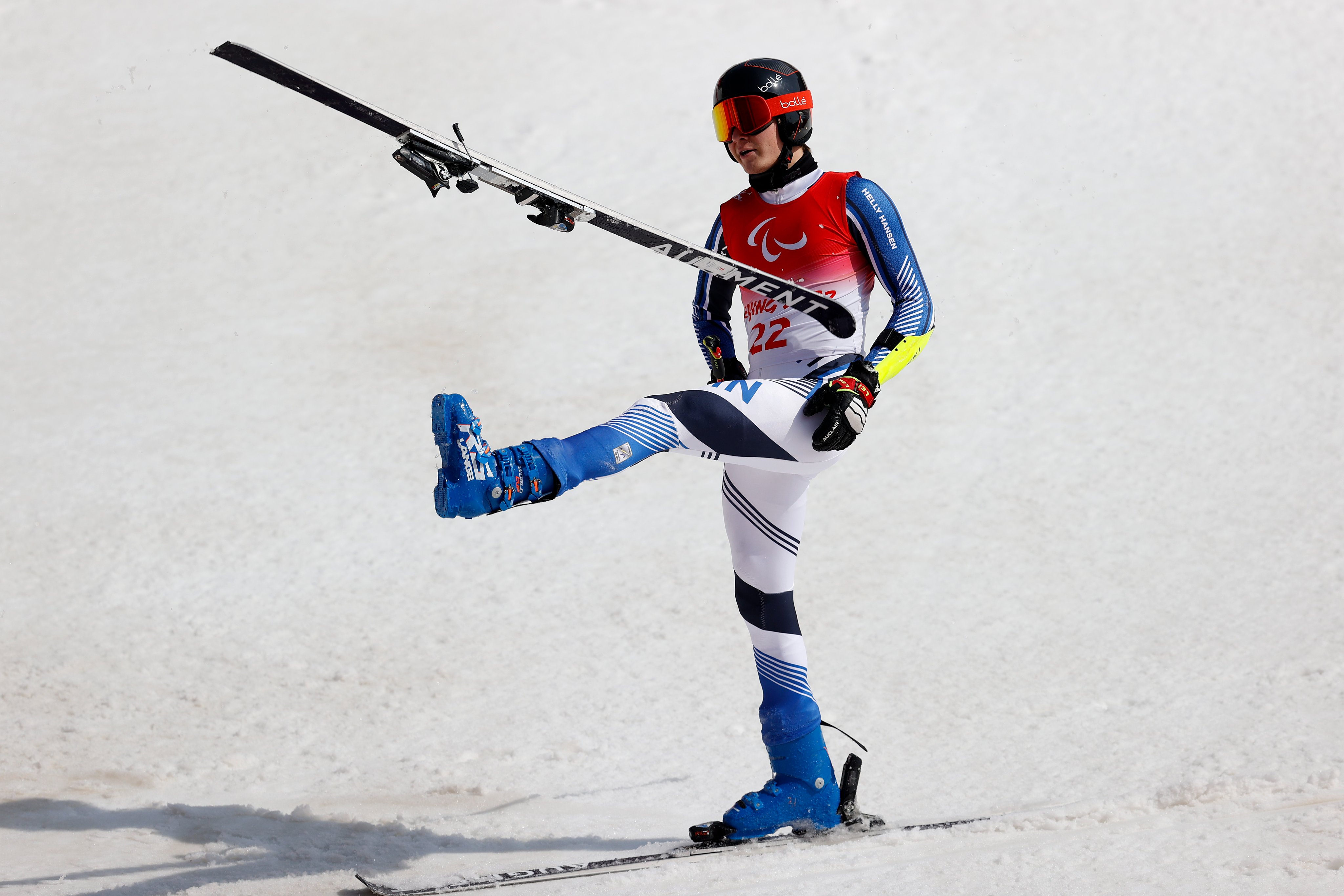 Santeri Kiiveri kicks his ski off after winning gold. 