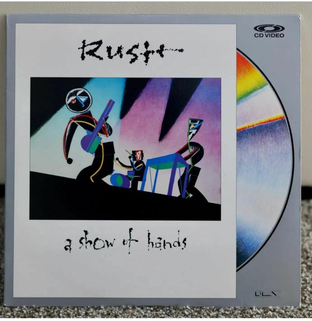 RushFanCast's tweet photo. This week on the @RushFanCast, we read an email from Adam from Detroit, AKA "The Rush Man", who shared images of his @rushtheband laser disc collection with us! These are very cool. Anyone else in the #RushFamily have any laser discs to share? #LaserDisc #RushLive #TheRushMan https://t.co/ztR0cmT2D5