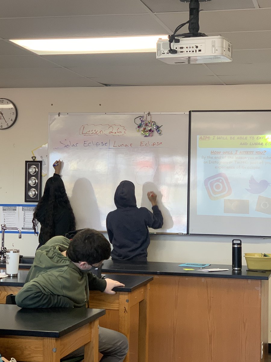 mineolahs's tweet photo. Samantha and Kevin explaining a lunar and solar eclipse and then the class sharing Instagram stories and Twitter posts to demonstrate understanding. #MineolaProud #Science8 https://t.co/SY6lYZmQR4