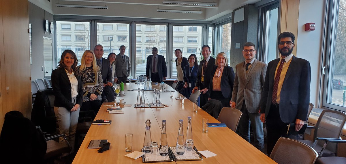 People standing for a picture around a table
