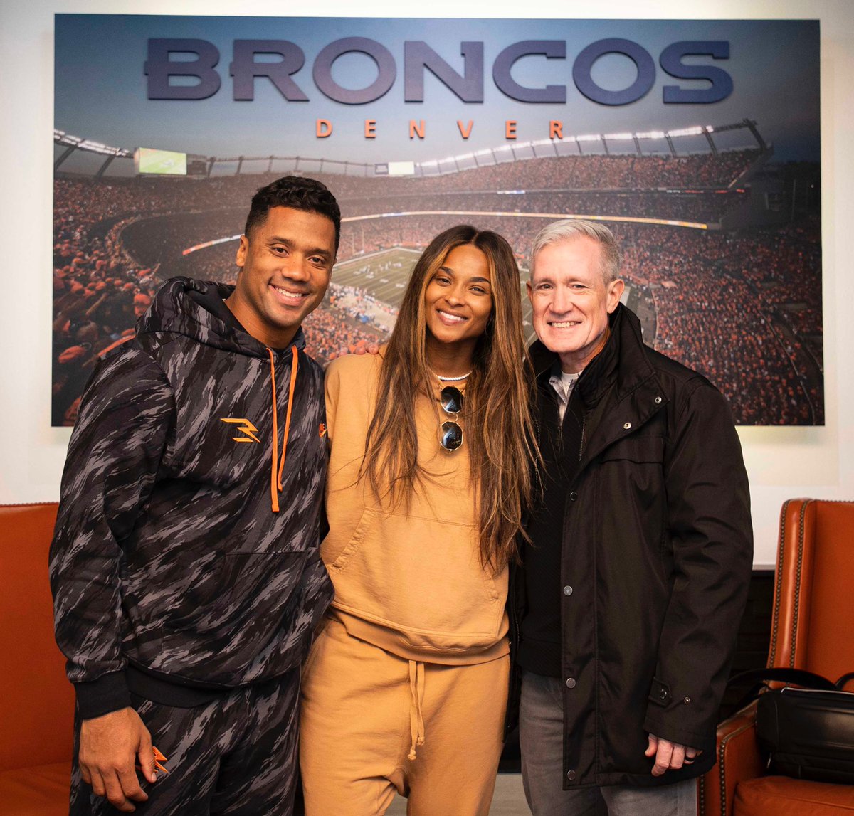 MySportsUpdate's tweet photo. Russell Wilson is already in Denver, rocking a #Broncos hoodie. Here he is in the facility with his wife Ciara and his agent Mark Rodgers.

(📸 @FrontlineAM) https://t.co/OFEKsmBvfC