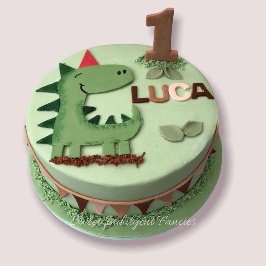 1 year old Luca had a dinosaur themed cake for his birthday.  Lucas Mum chose vanilla sponge with strawberry conserve and vanilla buttercream. #dinosaurcakes #firstbirthdaycakes #childrenscakes #bespokecakes #bournemouthcakemaker