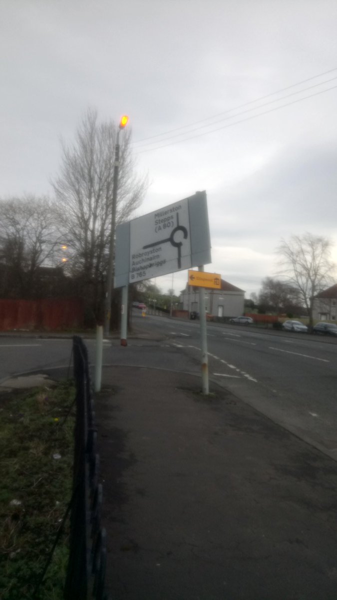 DonRedman13's tweet photo. @GlasgowCC this road sign has been like this for a little while now, clearly dangerous to pedestrians and road users. I am assuming that no-one at the council is aware of it, otherwise action would have been taken by now. It's Royston Rd, at Robroyston Rd. https://t.co/6P58a5PWJj