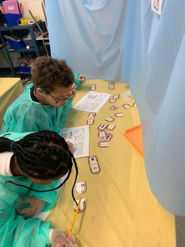 VanceCoSchools's tweet photo. Students @EMRollinsSTEAM1 applied what they learned about fractions.These fraction doctors visited 4 rooms, each w/ fraction related tasks:X-Ray, Surgery, Medical Charts &amp; ER! Lab coats were provided by a school partner for this innovative experience for Ms. Watkin's 3rd graders. https://t.co/vsqgLSg4b3